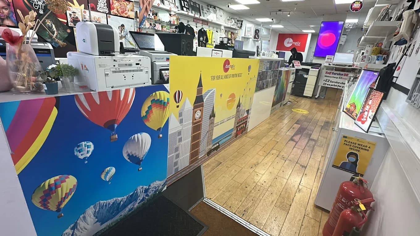 Inside the shop, looking down the print counter towards the back of the studio